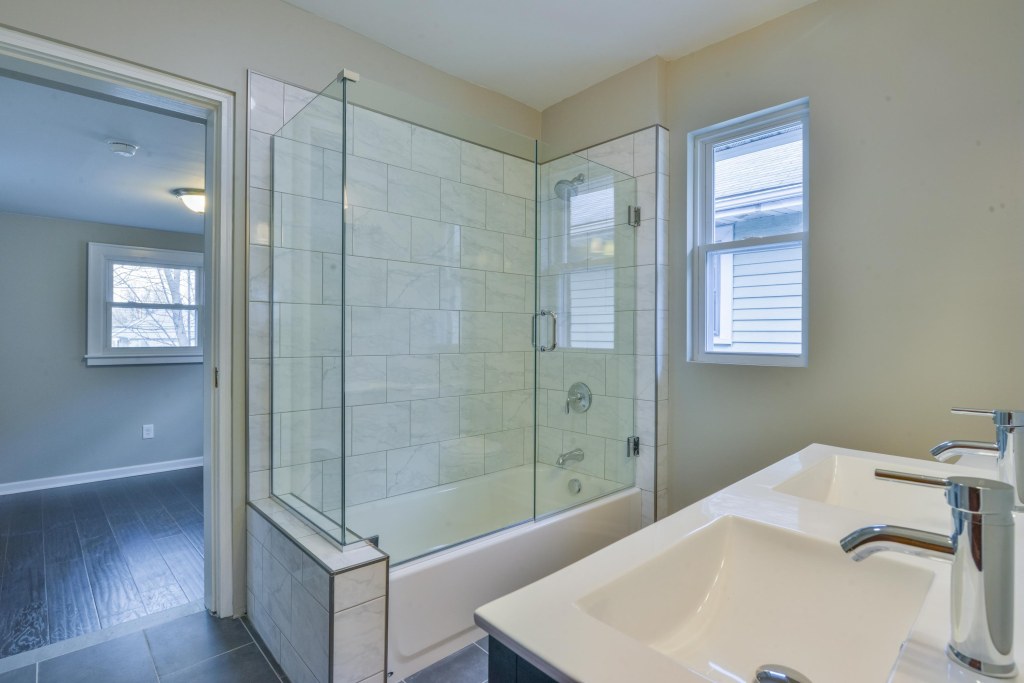 286 E Woodrow Avenue - Ceramic tile bath surround with frameless glass shower door